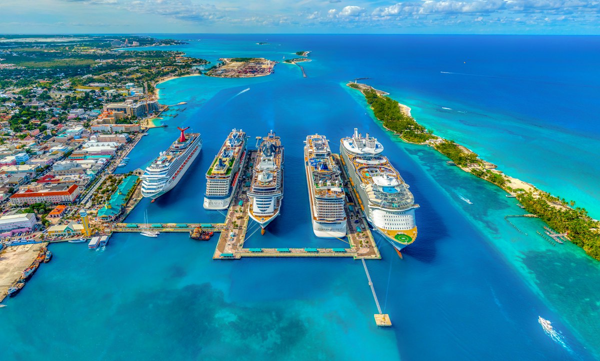 Aerial view of cruise ships docked in a turquoise harbor