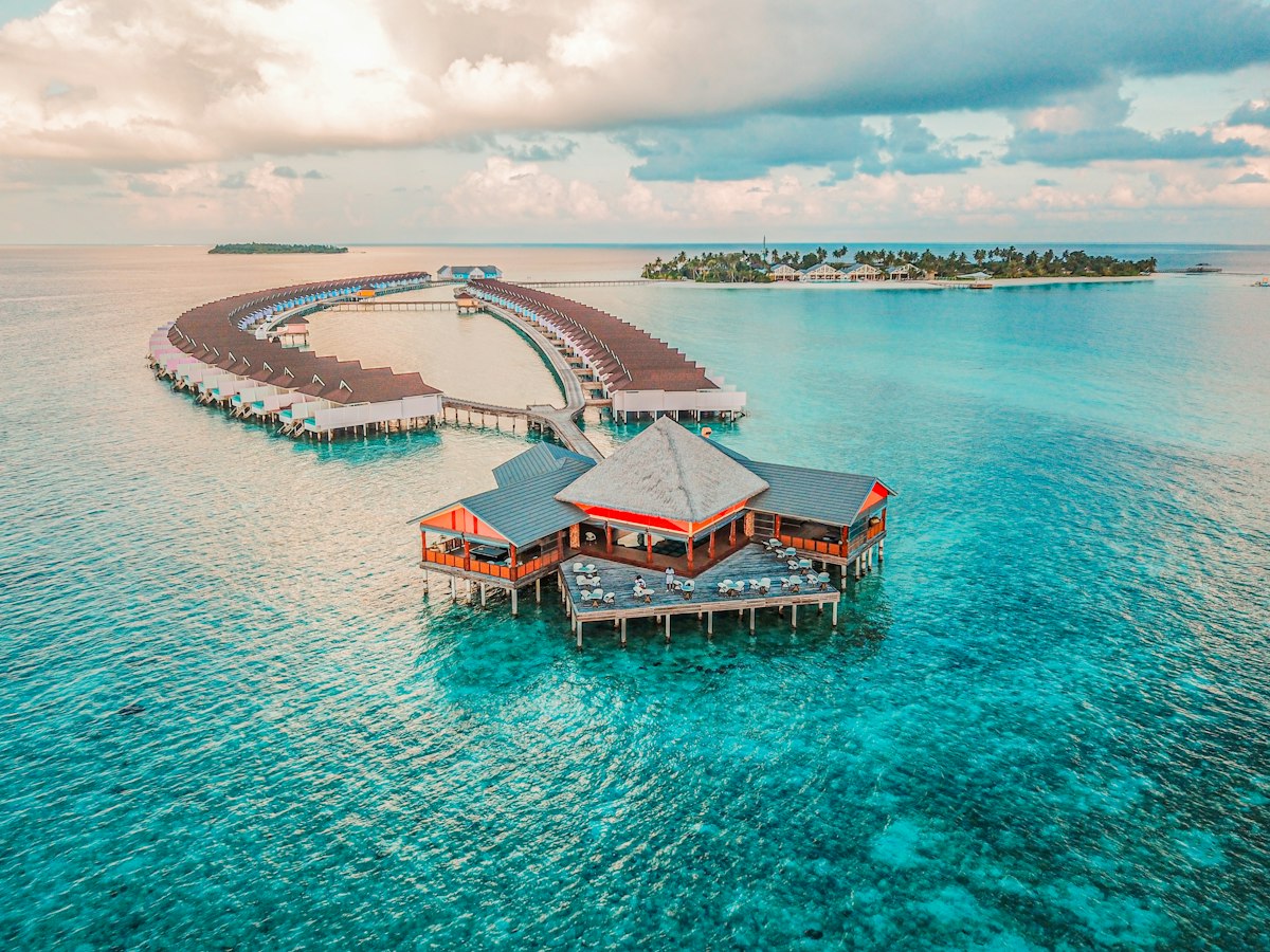 Overwater villas surrounded by turquoise lagoon water